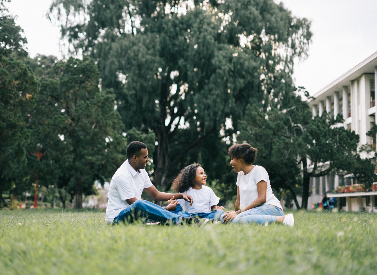 Happy family laughing together outdoors in a park